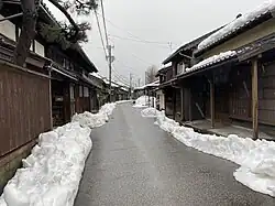 Street with traditional wooden houses in winter.