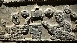 A relief depicting two men gambling