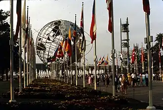 View of the Unisphere, a steel structure depicting the Earth; there are world flags in the foreground