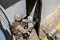 A pry bar being used to breach a door