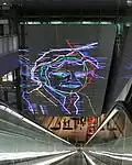 Artwork depicting Ramses Shaffy over the southern escalators