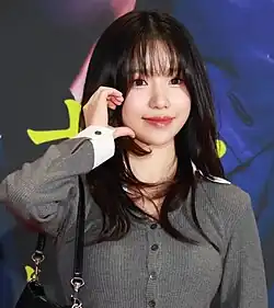 Jo waving to photographers on the red carpet for a movie screening.