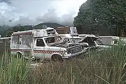 A burned ambulances and other damaged and destroyed vehicles