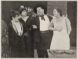 At left in A Lucky Strike (1915), with Oliver Hardy, Cora Walker and Mae Hotely