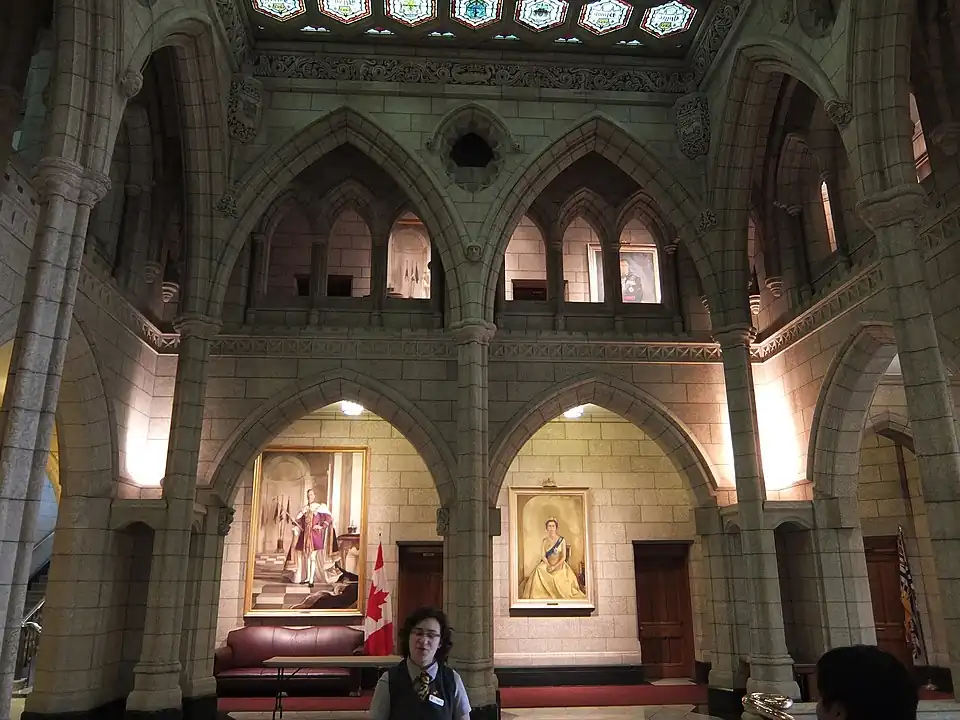 A tour guide waits for people to gather around her in the Senate foyer.
