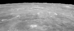 Oblique view facing south from Apollo 15, with Agrippa right of center, and the crater Godin above center showing bright rays.