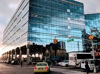 Exterior of the AirTrain station building at Jamaica station. The building has a blue glass facade.