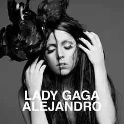 Greyscale image of Lady Gaga with unkempt black hair which falls around her face. A crow sits on top of her head.
