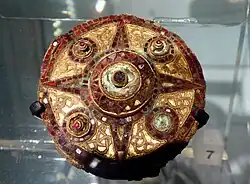 A Saxon copper brooch, decorated with gold and garnets