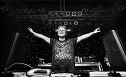 A picture of a DJ acknowledging the audience