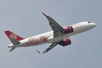 A Juneyao Air Airbus A320neo, painted in a special Fuping Dried Persimmon livery in 2023