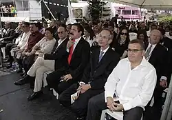 Several people observing Óscar Romero's beatification ceremony