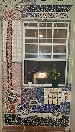 On the landing of first floor of the 1620 building a blue 1930s sport convertible car