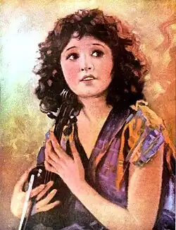 Portrait of Betty Compson holding a violin