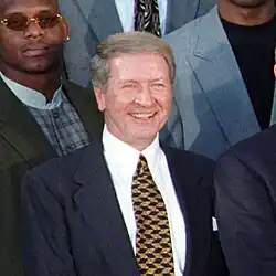 Portrait of Harlan smiling in a suit