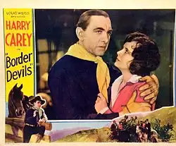 Lobby card for the American western film Border Devils (1932) with Harry Carey and Kathleen Collins (1903 – 1994).