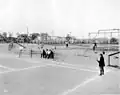 Boys playing tennis at the park, 1913