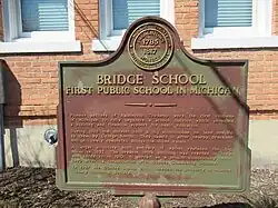 A county historic marker recognizing the former school