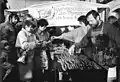 Border crossers being treated to free sausages, sandwiches, wine, coffee and cake on the Thuringian side of the new border crossing between Herleshausen and Lauchröden in Eisenach in December 1989