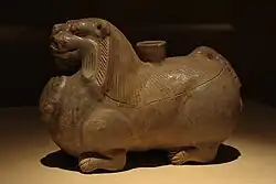 A celadon ceramic candle holder in the shape of a crouched lion, Three Kingdoms period (220–265), made in Eastern Wu