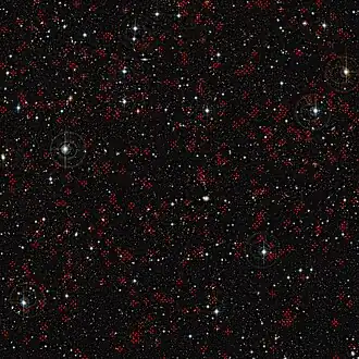 COSMOS field imaged by the Canada France Hawaii Telescope (CFHT). Red crosses mark some of the active galaxies with supermassive black holes at their centers.