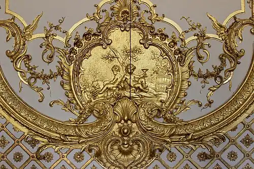 Rococo cartouche with putti in the Cabinet de la Pendule, Palace of Versailles, France, created and sculpted by Jacques Verberckt, 1738[15]