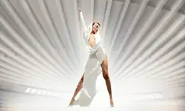 Minogue wearing a white hooded jumpsuit