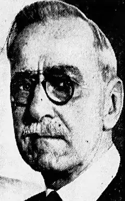 Black-and-white newspaper image of Stansbury in a suit