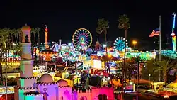 Fair & Date Fest at night from the sky showing the Celebration stage and carnival rides in the background