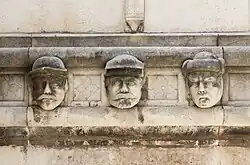 Heads on the exterior depict unknown individuals