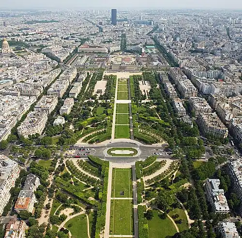 Image 9 Champ de Mars Photo credit: David Iliff Champ de Mars (Paris, France), as seen from the observation deck of the Eiffel Tower. In the distance is Tour Montparnasse and the dome on the left is Les Invalides. The École Militaire is at the end of the Champ de Mars. In English the name means "Field of Mars", from Mars the Roman god of war, from its original use for military training. During the French Revolution, the Champ de Mars was the setting of the Fête de la Fédération, on 14 July 1790. More selected pictures