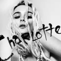 A black-and-white close-up of a young woman with blonde hair, with the name "Charlotte" written across her face in black paint or ink.