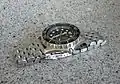 A watch with a segmented stainless steel watch bracelet.