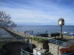 A square with a clock in it, in front of a beach
