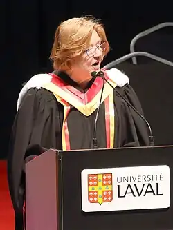 McCain in academic dress giving a speech.