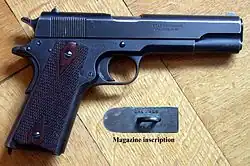 M1911 pistol "British Service Model", which uses the Webley Auto Mk I cartridge. The weapon is stamped with ".455" on the slide and the underside of the magazine