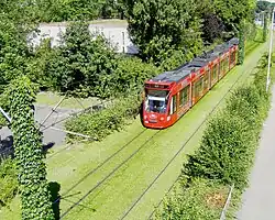 Freiburg Combino on green track.