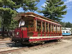 Operator on red trolley operating on an electric railway