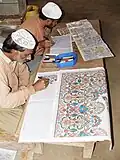 Central Jail Faisalabad offers recreational programmes for prisoners – Two convict artists busy in drawing designs of carpets on graph papers at Industrial Workshops of the jail, in 2010