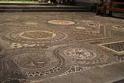 The Cosmati pavement: an elaborately-patterned floor with geometric designs with small red, brown, black and gold tiles