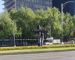 alt:Two crosses, one erect and the other bent. On the first one is written the phrase "My voice will never die", while on the two there are multiple names written.