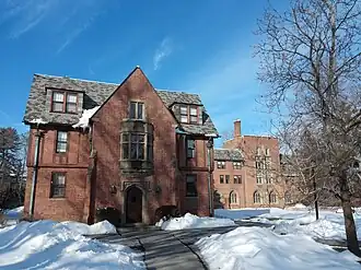 A winged brick building on a clear day, with snow on the ground