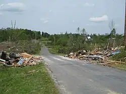 A road with damaged structures lining its sides.