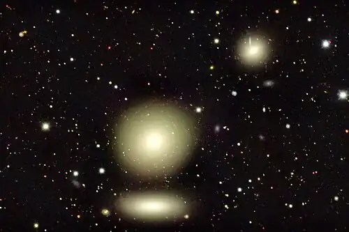 The three large objects in this image captured by the Dark Energy Camera are galaxies in the nearby Fornax cluster, roughly 65 million light-years from Earth.