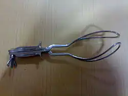 Das's modification to the long curved delivery forceps with the blades locked in place