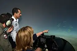 Deborah Lee James, then USAF chief, has a flight simulator at Hatzor explained to her in 2015