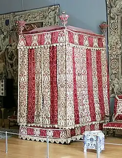 Four-poster bed from the Château d'Effiat; c.1650; natural walnut, chiselled Genoa silk velvet and embroidered silks; 295 cm; Louvre[123]