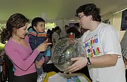 A volunteer displays a celestial globe for a young visitor, 2010