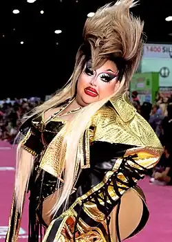 Photograph of a person wearing a black-and-gold outfit