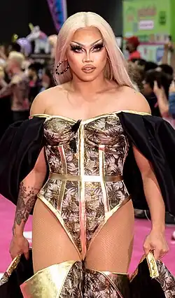 Photograph of a person wearing a black-and-gold outfit